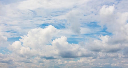 White curly clouds on the background of light blue sky. Preparation for design_