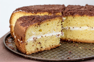 Sliced to pieces cake on the tray, sweet dessert_