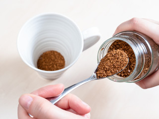 female hand spooning up second portion of coffee
