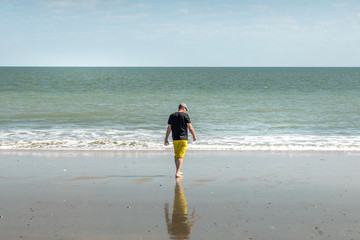 Man walking on a sandy beach