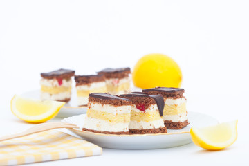 Lemon cake and pieces of lemon on white background. Homemade lemon cake.