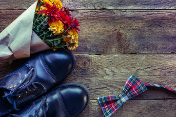 Male leather elegant shoes, flowers over wooden background. Happy farthes d