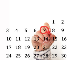 hand encircling date in calendar