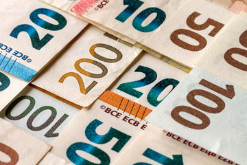 Money and finances concept. Bright colorful abstract surface, background of euro national currency different bills. Banknotes worth ten, twenty, fifty, hundred and two hundred euro.