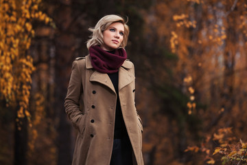 Young fashion woman walking in autumn park
