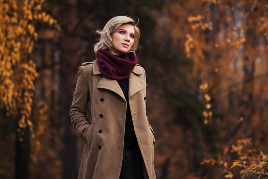 Young fashion woman walking in autumn park