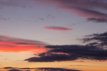 Naklejka na ściany i meble Stunning vivid multiple colors of clouds on a dramatic sunset sky