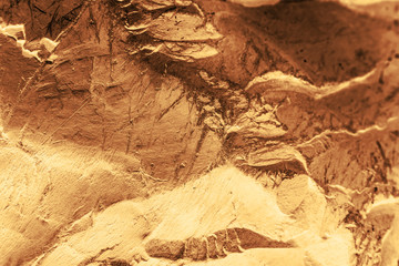 Vintage yellow background. Rough painted wall of aspen gold color. Imperfect plane of golden colored. Uneven old decorative toned backdrop of yellow tint. Texture of gold hue. Ornamental stony surface