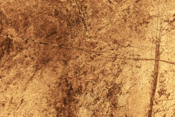 Vintage yellow background. Rough painted wall of aspen gold color. Imperfect plane of golden colored. Uneven old decorative toned backdrop of yellow tint. Texture of gold hue. Ornamental stony surface