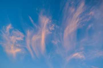 The sky with dark clouds illuminated by the setting sun