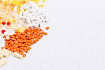 Pills and vitamins on a white background. Different drugs in capsules and tablets. Copy space,