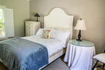 Guest Bedroom in a House with a Headboard and bed and table and dresser