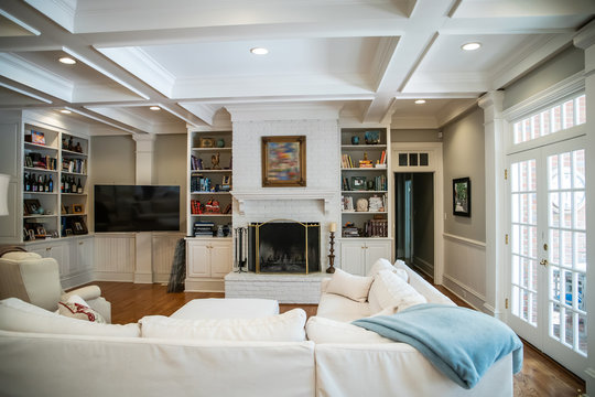 Large Living Room Den in Home with Vaulted Tray Ceiling and bookshelves