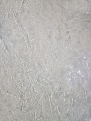 Beach sand Ocean waves with foam on the sand. Top view