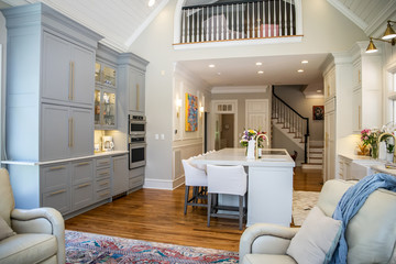 View of Upper Loft of Open Concept Home with eat in kitchen and Wood railing and Can Lighting