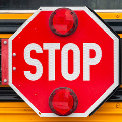 Clear Square Close up of an octagon shaped red stop sign with signal lights on a school bus