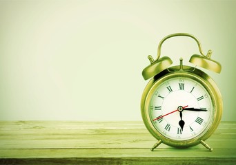 Retro alarm clock on table  background
