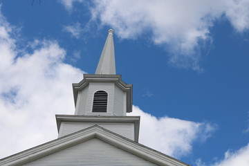 White wooden church steeple in historic New England town