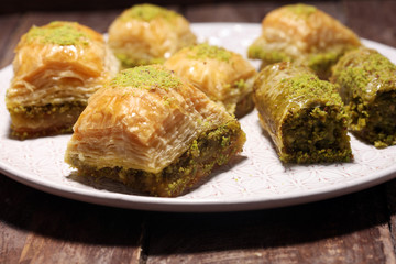 Middle eastern or arabic dishes. Turkish Dessert Baklava with pistachio on dishes