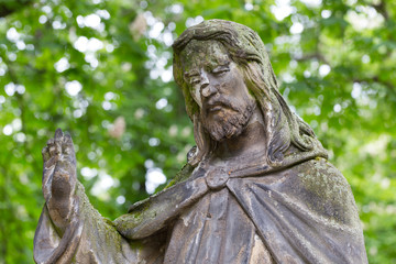 Fototapeta premium Historic Jesus on the mystery old Prague Cemetery, Czech Republic