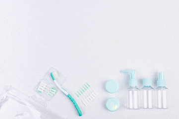 Toothbrush and plastic containers for travel on a white background and chopsticks. Flat lay.