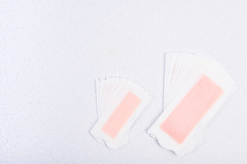 Wax strips for hair removal on a white background. Spa and beauty treatments. Free space for text. Copy space.