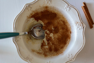 Eating Oatmeal with cinnamon in a bowl