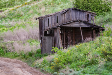 Old abandoned wooden rural hut in countryside