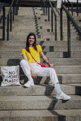 Young pretty smiling girl sitting on stairs