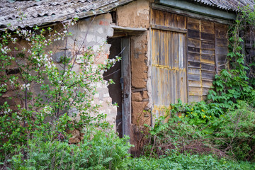 Old abandoned wooden rural hut in countryside