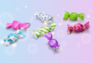 Assortment of wrapped candies  on white background