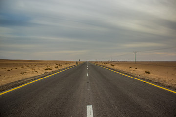 car highway road desert sand dunes calming scenic landscape in cloudy weather time, daily planet concept picture from Middle East Earth region in Jordan country  