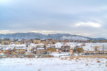 Frosty town with homes that contrast with the blanket of snow in winter
