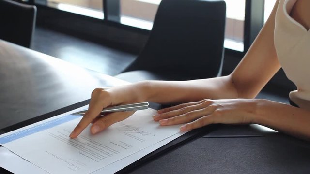Asian business woman signing agreement for business contract.