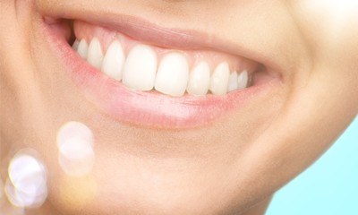 Obraz premium Beautiful wide smile of young fresh woman with great healthy white teeth. Isolated over white background