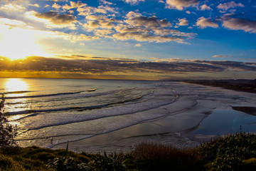 sunset over the ocean, Muriwai beach close to Auckland, north island, New Zealand.