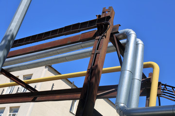 Outdoor industrial pipes of manufacturing plant on a sunny day