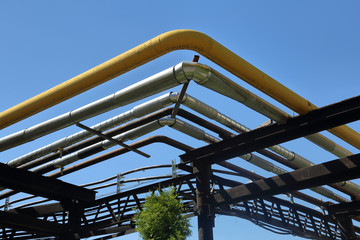 Outdoor industrial pipes of manufacturing plant on a sunny day