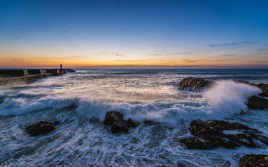 Sunset over Atlantic Ocean. View from breakwater in Porto, Portugal