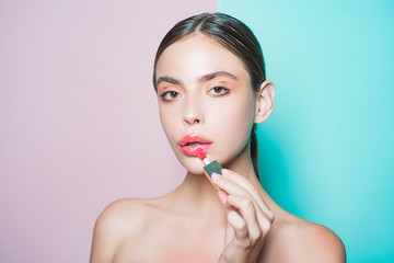 Woman put makeup on her face. Daily makeup concept. Makeup and cosmetics. Girl healthy shiny skin put makeup on. Add more details. Fashion model. Beauty routine. Girl hold cosmetic applicator