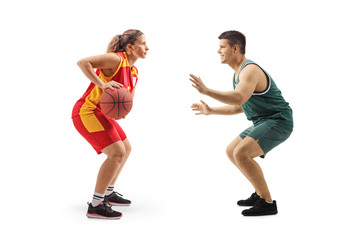 Female basketball player playing with a male basketball palyer
