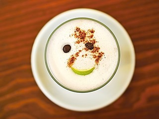 Spanish small three-storey coffee with liqueur and a slice of lemon