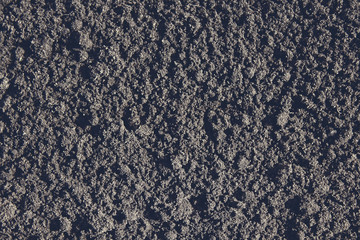 Black soil in the garden. Close-up. Background. Texture.