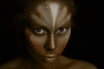 Art photo of Africal woman with tribal ethnic paintings on her face
