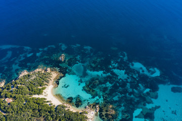 Naklejka na ściany i meble View from above, stunning aerial view of the Capriccioli Beach bathed by a beautiful turquoise sea. Costa Smeralda (Emerald Coast) Sardinia, Italy.