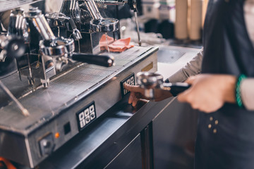Fototapeta na wymiar Close up of barista using group espresso machine