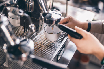 Close up of barista making coffee in espresso machine