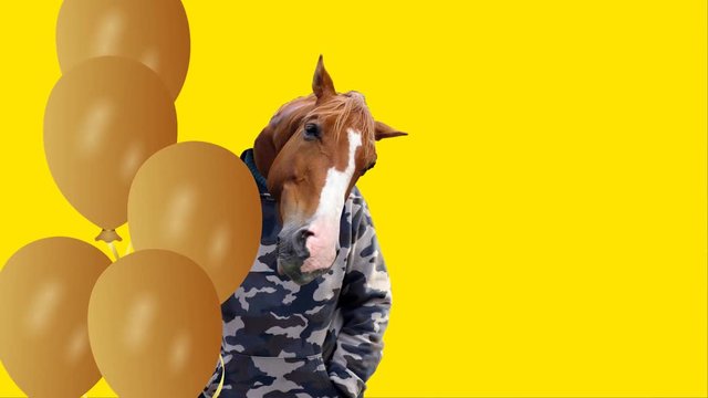Swaying man with a horse head and flying yellow balloons, funny congratulation with space for your text, 4K video