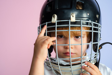 Hockey or rugby helmet. Sport childhood. Future sport star. Sport upbringing and career. Boy cute child wear hockey helmet close up. Safety and protection. Protective grid on face. Sport equipment