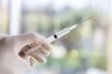 Doctor's hand holding a syringe